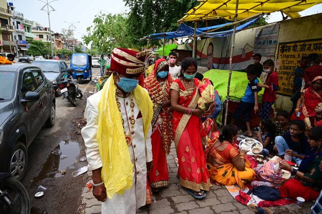 May 3, 2021, Prayagraj, Uttar Pradesh, India: Prayagraj: A Newly married couple arrived to perform prayer outside closed Alopi Devi Temple during government imposed weekend Lockdown in Prayagraj on Monday, May 03, 2021. Prayagraj India - ZUMAv115 20210503_zap_v115_027 Copyright: xPrabhatxKumarxVermax