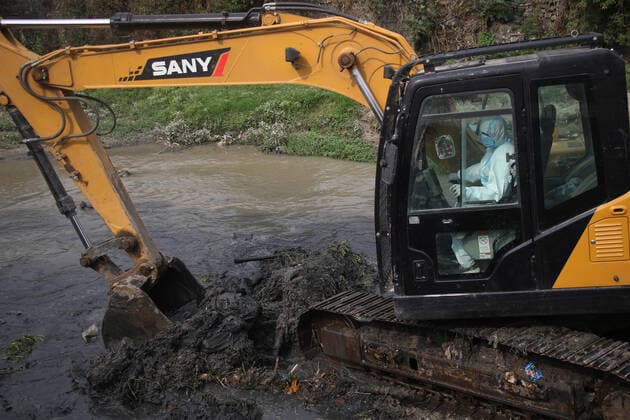 May 3, 2021, Kathmandu, NE, Nepal: A person operates an excavator to clear the ground to arrange a pyre on the bank of the Bagmati river to cremate CovidÃ¢â‚¬19 victims as the number of deaths increases, in Kathmandu, Nepal, May 3, 2021. Kathmandu Nepal - ZUMAd164 20210503_zip_d164_002 Copyright: xAryanxDhimalx