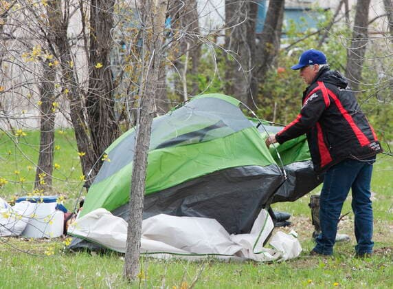 May 3, 2021, Montreal, PQ, Canada: A man takes down his tent at a homeless camp in the east end of Montreal, Monday, May 3, 2021. Authorities have ordered the camp to be taken down. Montreal Canada  - ZUMAc35_ 20210503_zaf_c35_003 Copyright: xRyanxRemiorzx