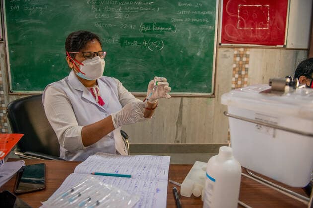 May 3, 2021, New Delhi, India: A health worker prepares the dose of Coronavirus vaccine at the Sarvoday Kanya Vidyalay West Vinod Nagar where a temporary vaccination centre has been converted..Third phase of Covid-19 Mass Vaccination Drive for People above 18 begins in Delhi capital of India. According to Delhi Deputy Chief Minister Manish Sisodia. 301 Vaccination centres set-up in 76 schools across Delhi, Vaccinating Today 45,100 Delhi Citizens, Next few days 3000 Vaccination centres will start operating in 300 schools across Delhi. New Delhi India - ZUMAs197 20210503_zaa_s197_049 Copyright: xPradeepxGaurx