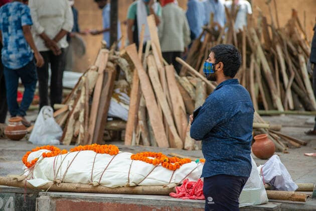 May 3, 2021, New Delhi, India: EDITORS NOTE (Image depicts death).A man stands next to a funeral pyre of a loved one who died of COVID19 during a mass cremation at Ghaziapur Municipal crematorium..Mass cremations in New Delhi, capital of India faces deluge of COVID-19 deaths, in the last 24 hours India has officially recorded 3417 covid-19 deaths. New Delhi India - ZUMAs197 20210503_zaa_s197_092 Copyright: xPradeepxGaurx