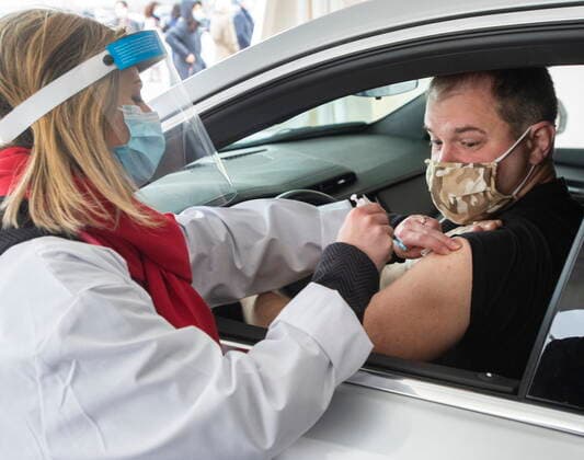 May 4, 2021, Montreal, PQ, Canada: Alex Smirnov gets a COVID-19 vaccination from Annie Halinka Sanson at a demonstration of a drive-through vaccination site, Tuesday, May 4, 2021 in Montreal. The site will be able to give 4,000 doses a day. Montreal Canada  - ZUMAc35_ 20210504_zaf_c35_003 Copyright: xRyanxRemiorzx