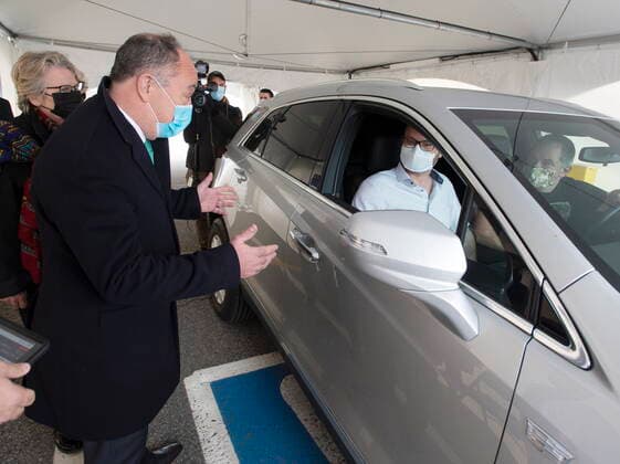 May 4, 2021, Montreal, PQ, Canada: Quebec Health Minister Christian Dube, left, chats with Alex Smirnov, centre, and Timur Tchanychev, right, at a demonstration of a drive-through vaccination site, Tuesday, May 4, 2021 in Montreal. The site will be able to give 4,000 doses a day. Montreal Canada  - ZUMAc35_ 20210504_zaf_c35_004 Copyright: xRyanxRemiorzx