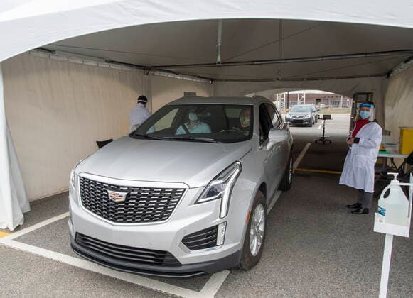 May 4, 2021, Montreal, PQ, Canada: Alex Smirnov, driver, and Timur Tchanychev, passenger, pull out of the tent after receiving their COVID-19 shots at a demonstration of a drive-through vaccination site, Tuesday, May 4, 2021 in Montreal. The site will be able to give 4,000 doses a day. Montreal Canada  - ZUMAc35_ 20210504_zaf_c35_005 Copyright: xRyanxRemiorzx