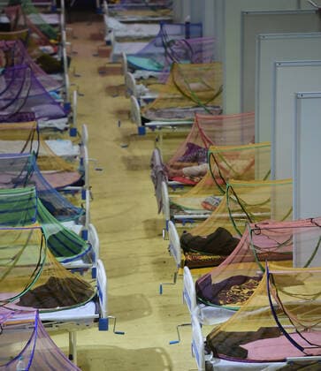 COVID-19 patients at a sports complex, converted into a Covid care center, receive care in New Delhi, India, Tuesday, May 4, 2021. More than 20 million Indians have been infected with the coronavirus as it continues to spread with 3,500 deaths in the past 24 hours.  DEL2021050411 Abhishek