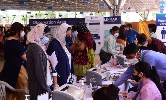People over 18 years of age fulfill formalities to receive COVID-19 vaccine doses at one of the largest vaccination sites at Radhaswami Satsang, in New Delhi, India, Tuesday, May 4, 2021. More than 20 million Indians have been infected with the coronavirus as it continues to spread with 3,500 deaths in the past 24 hours.  DEL20210504251 Abhishek
