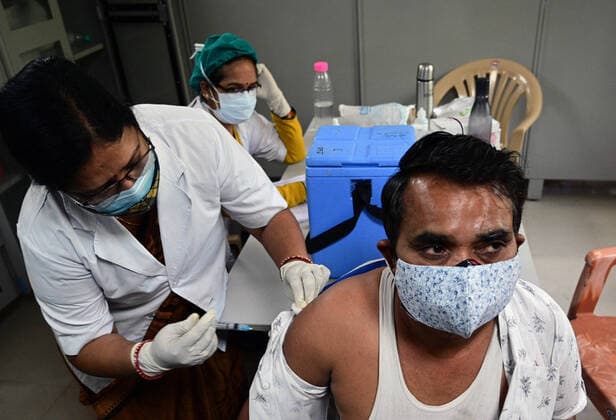 May 5, 2021, Prayagraj, Uttar Pradesh, India: Prayagraj: A medical worker inoculates a man with a dose of Covaxin vaccine against the Covid-19 coronavirus at Moti Lal Nehru Medical College in Prayagraj on Wednesday, May 05, 2021. Prayagraj India - ZUMAv115 20210505_zap_v115_013 Copyright: xPrabhatxKumarxVermax