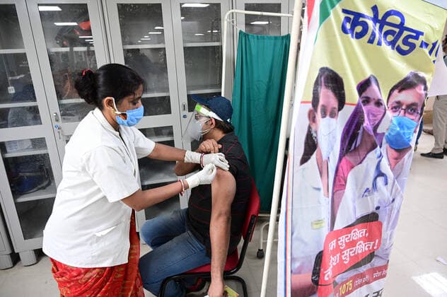 May 5, 2021, Prayagraj, Uttar Pradesh, India: Prayagraj: A medical worker inoculates a girl with a dose of Covaxin vaccine against the Covid-19 coronavirus at Moti Lal Nehru Medical College in Prayagraj on Wednesday, May 05, 2021. Prayagraj India - ZUMAv115 20210505_zap_v115_023 Copyright: xPrabhatxKumarxVermax
