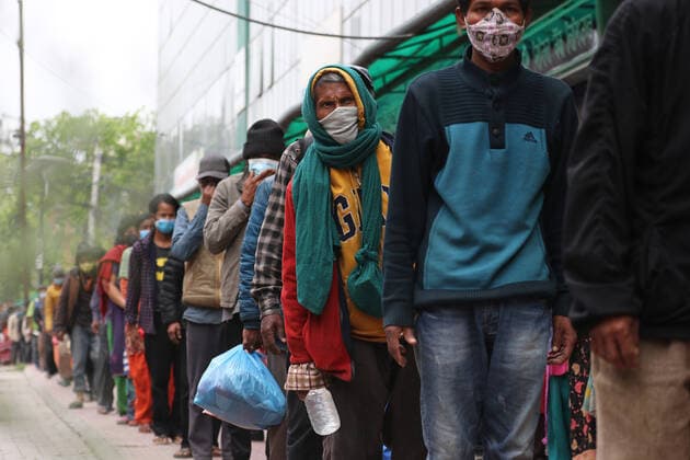 May 5, 2021, Kathmandu, NE, Nepal: People wait for the morning meal provided by the 100 s Group, a youth charity, during the lockdown in Kathmandu, Nepal, May 5, 2021. Kathmandu Nepal - ZUMAd164 20210505_zip_d164_008 Copyright: xAryanxDhimalx
