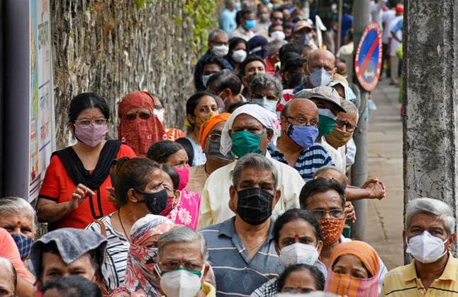 May 5, 2021, Mumbai, India: People wearing face masks stand in a queue outside NESCO vaccination center to receive their COVID19 dose in Mumbai..Vaccination drive which was stopped for people above 45 years of age last week started again with the availability of vaccine stock. Mumbai India - ZUMAs197 20210505_zaa_s197_028 Copyright: xAshishxVaishnavx