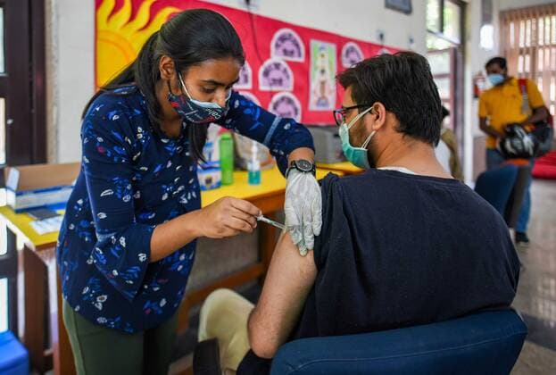 NEW DELHI, INDIA - MAY 5: A person in the age group of 18-44 gets inoculated with a Covid-19 vaccine during the third phase of vaccination, at Girls senior secondary school, Chhatarpur on May 5, 2021 in New Delhi, India. (Photo by Amal KS Hindustan Times) COVID-19 Vaccination Drive
