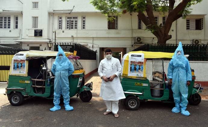 NEW DELHI, INDIA - MAY 5: Rajya Sabha MP Sanjay Singh with Auto-Rickshaw Driver in personal cover protective equipment (PPE) launched an auto ambulance fitted with oxygen cylinder free ride service for the COVID-19 patients to hospitals on May 5, 2021 in New Delhi, India. (Photo by Sonu Mehta Hindustan Times) Auto-Ambulances With Oxygen Support Launched In Delhi