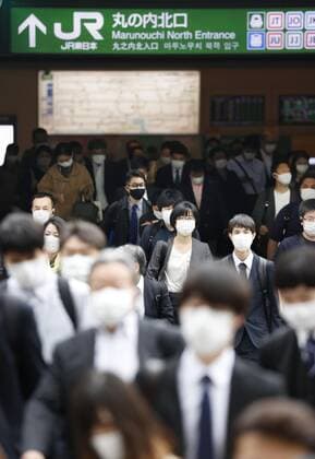 Commuters in Tokyo after Golden Week holiday period People wearing face masks walk in front of Tokyo Station amid the coronavirus pandemic during the morning commute on May 6, 2021, the first weekday after the end of the Golden Week holiday period in Japan. 