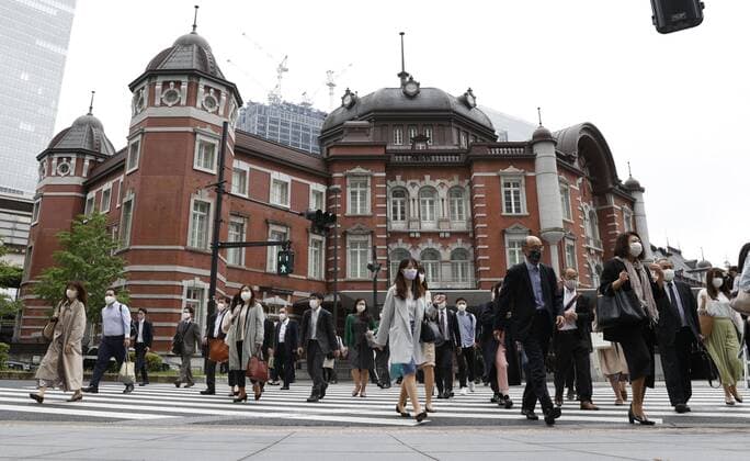Commuters in Tokyo after Golden Week holiday period People wearing face masks walk in front of Tokyo Station amid the coronavirus pandemic during the morning commute on May 6, 2021, the first weekday after the end of the Golden Week holiday period in Japan. 