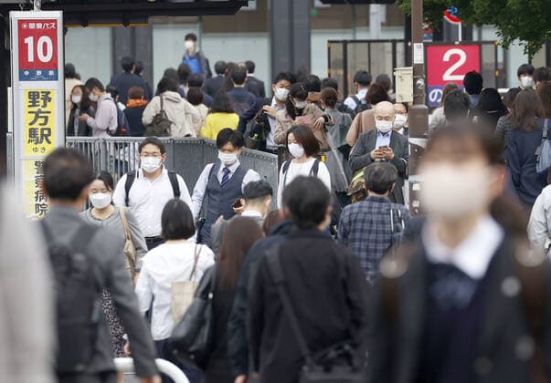 Commuters in Tokyo after Golden Week holiday period People wearing face masks head to a station in Tokyo s Nakano Ward amid the coronavirus pandemic during the morning commute on May 6, 2021, the first weekday after the end of the Golden Week holiday period in Japan. 
