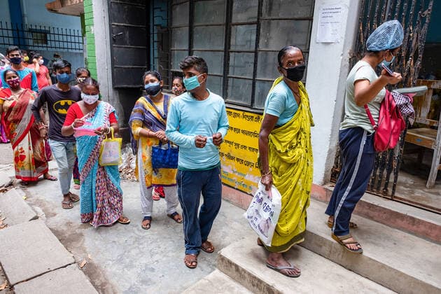 May 6, 2021, Kolkata, West Bengal, India: People stand in a long queue with no social distance before getting a Covid19 test in a testing kiosk at Madhyamgram rural hospital..Covid19 testing is being done everywhere in India to trace the COVID19 Infected patients so as to curb the raising number of COVID19 infection. Kolkata India - ZUMAs197 20210506_zaa_s197_030 Copyright: xDipayanxBosex