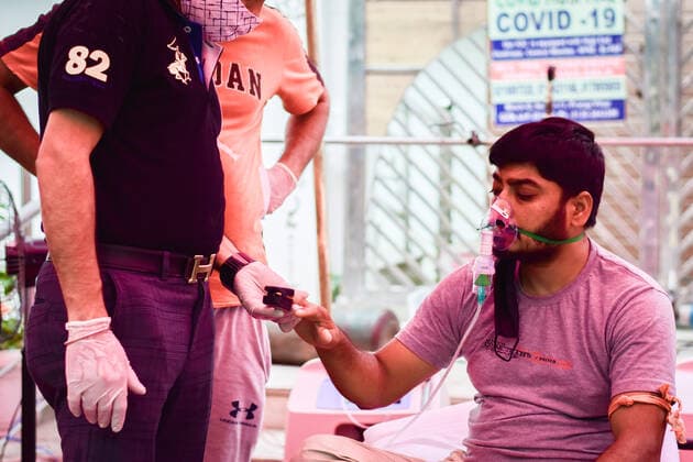 May 6, 2021, Ghaziabad, Uttar Pradesh, India: A patient suffering from Covid-19 is treated with free oxygen at a makeshift clinic outside the Gurdwara Damdama Sahib. India faces shortage of medical oxygen and in such circumstances an NGO known as Khalsa Help International helps Covid-19 patients by offering them free oxygen. Ghaziabad India - ZUMAs197 20210506_zaa_s197_063 Copyright: xManishxRajputx xSOPAximagesx