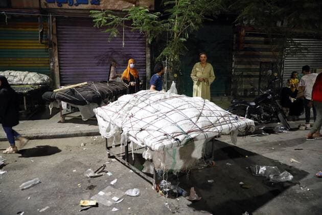 (210506) -- CAIRO, May 6, 2021 -- Vendors cover their stalls at a night market in Cairo, Egypt, on May 6, 2021. Egyptian Prime Minister Mostafa Madbouly on Wednesday announced two-week new precautionary measures to control the spread of the COVID-19. Madbouly said in a televised press conference that restaurants, cinemas, shops, malls, clubs and entertainment facilities will be closed at 9 p.m. local time (1900 GMT) for two weeks starting the evening of Thursday, just ahead of the end of the Islamic holy month of Ramadan and the feast festival Eid al-Fitr. ) EGYPT-CAIRO-COVID-19-MEASURES AhmedxGomaa 