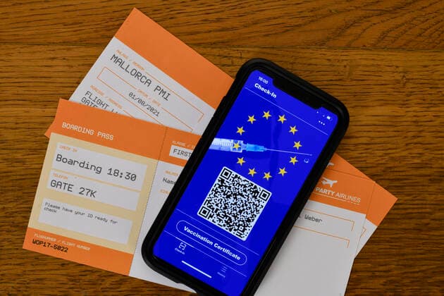 Symbol photo vaccination privileges, smartphone with digital European vaccination card with QR code, boarding passes for air travel, Corona crisis, Germany Coronavirus
