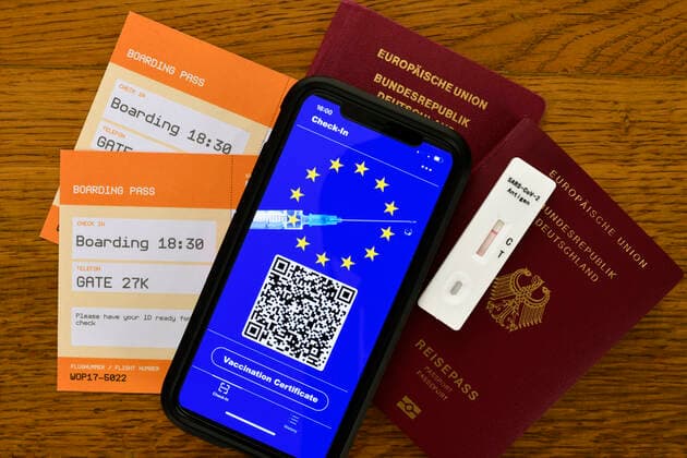 Symbol photo vaccination privileges, smartphone with digital European vaccination passport with QR code, passport, boarding passes for air travel, quick test, Corona crisis, Germany Coronavirus