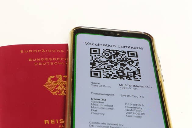 Symbolic passport and a digital green passport as proof of vaccination Copyright: xx