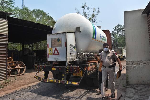 NEW DELHI, INDIA - MAY 7: Police personnel escorting a truck carrying medical oxygen for Covid-19 patients at Sarai Kaley Khan on May 7, 2021 in New Delhi, India. (Photo by Raj K Raj Hindustan Times) India Faces Oxygen Crisis As Covid-19 Cases Mount