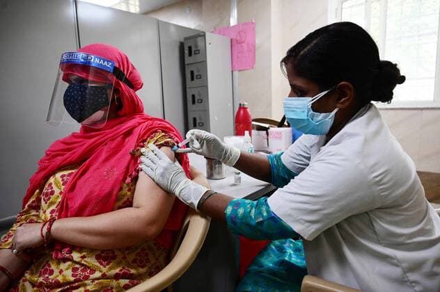 May 8, 2021, Prayagraj, Uttar Pradesh, India: Prayagraj: A medical worker inoculates a youth with a dose of Covaxin, vaccine against the Covid-19 coronavirus at Moti Lal Nehru Medical College in Allahabad on Thursday, May 08, 2021. Prayagraj India - ZUMAv115 20210508_zap_v115_013 Copyright: xPrabhatxKumarxVermax