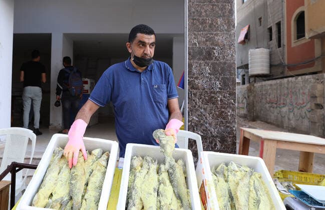 May 8, 2021, Gaza city, Gaza Strip, Palestinian Territory: Palestinian men wearing masks, prepare salted fish to be sold in markets ahead Eid al Fitr holiday in Gaza City, on May 8, 2021. Salted fish, such as kippered herring or dried and salted cod, is fish cured with dry salt and thus preserved for later eating. Drying or salting, either with dry salt or with brine, was the only widely available method of preserving fish until the 19th century Gaza city Palestinian Territory - ZUMAap3_ 20210508_zaf_ap3_075 Copyright: xMahmoudxAjjourx