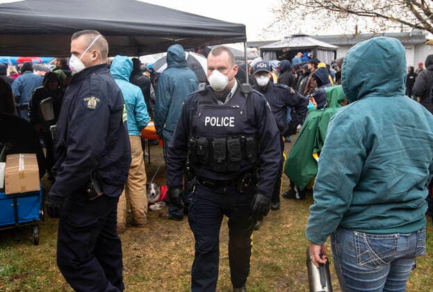 May 8, 2021, Mirror, ab, Canada: Police walk through the crowd during a rally against measures taken by government and health authorities to curb the spread of COVID-19 at the Whistle Stop cafe in Mirror Alta, on Saturday May 8, 2021. The Whistle Stop was shut down by AHS for not complying with COVID-19 rules. Mirror Canada  - ZUMAc35_ 20210508_zaf_c35_074 Copyright: xJasonxFransonx
