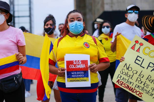 May 8, 2021, Mexico City, Mexico: A Colombian citizen holds a placard saying SOS Colombia, they are killing us during a protest in support of the National Strike in Colombia..Several demonstrations have been carried out in Mexico City rejecting the militarization exercised by the President of Colombia Ivan Duque Marquez. Mexico City Mexico - ZUMAs197 20210508_zaa_s197_230 Copyright: xGuillermoxDiazx