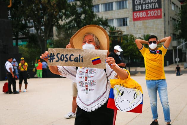 May 8, 2021, Mexico City, Mexico: A Colombian citizen holds a placard saying SOS Colombia during a protest in support of the National Strike in Colombia..Several demonstrations have been carried out in Mexico City rejecting the militarization exercised by the President of Colombia Ivan Duque Marquez. Mexico City Mexico - ZUMAs197 20210508_zaa_s197_246 Copyright: xGuillermoxDiazx