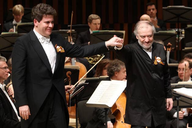 MOSCOW, RUSSIA â€” MAY 9, 2021: Pianist Denis Matsuev (L) and the artistic director of the Mariinsky Theatre, conductor Valery Gergiev (R) acknowledge the audience as they perform with the Mariinsky Theatre Symphony Orchestra at Zaryadye Concert Hall at the 20th Moscow Easter Festival, on Victory Day. Vladimir Gerdo TASS  TS0FFA37