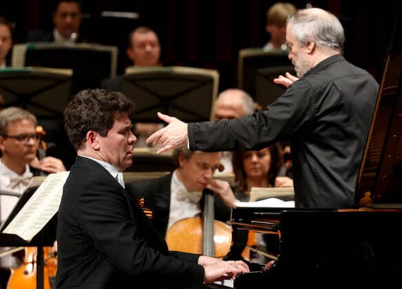 MOSCOW, RUSSIA â€” MAY 9, 2021: Pianist Denis Matsuev (L front) and the artistic director of the Mariinsky Theatre, conductor Valery Gergiev (R front) perform with the Mariinsky Theatre Symphony Orchestra at Zaryadye Concert Hall at the 20th Moscow Easter Festival. Vladimir Gerdo TASS  TS0FFA39