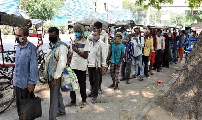 NEW DELHI, INDIA - MAY 9: Indian Youth Congress activists distribute food to needy persons during the lockdown in the capital due to covid 19 pandemic at DDU Marg (near Minto Road), on May 9, 2021 in New Delhi, India. (Photo by Sonu Mehta Hindustan Times ) Indian Youth Congress Activists Distribute Food During The Lockdown In Delhi
