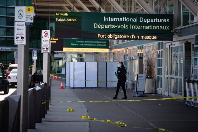 May 9, 2021, Richmond, BC, Canada: An RCMP officer works at the scene after a shooting outside the international departures terminal at Vancouver International Airport, in Richmond, B.C., Sunday, May 9, 2021. Richmond Canada  - ZUMAc35_ 20210509_zaf_c35_062 Copyright: xDarrylxDyckx