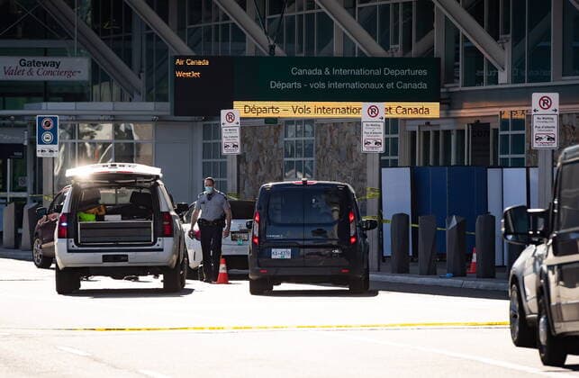 May 9, 2021, Richmond, BC, Canada: An RCMP officer works at the scene as screens block off an area of the sidewalk after a shooting outside the international departures terminal at Vancouver International Airport, in Richmond, B.C., Sunday, May 9, 2021. Richmond Canada  - ZUMAc35_ 20210509_zaf_c35_067 Copyright: xDarrylxDyckx