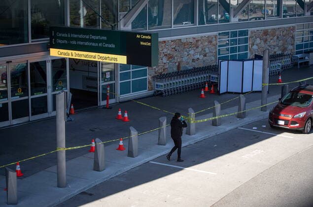May 9, 2021, Richmond, BC, Canada: An RCMP officer works at the scene of a shooting outside the international departures terminal at Vancouver International Airport as screens block off an area of the sidewalk, in Richmond, B.C., Sunday, May 9, 2021. Richmond Canada  - ZUMAc35_ 20210509_zaf_c35_077 Copyright: xDarrylxDyckx