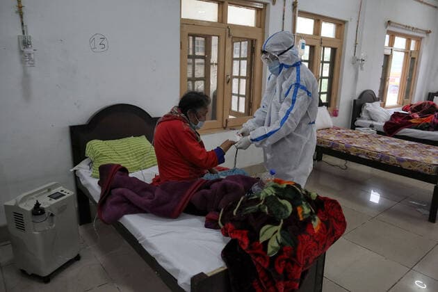 May 8, 2021: A Health worker examins a Covid-19 patient at a temporary Covid-19 hospital in Srinagar, Indian Administered Kashmir on 08 May 2021. A Local NGO Athrout has converted Hajj house into a 100-bedded Covid centre as the space in hospitals is filling up fast - ZUMAd99_ 20210508_zap_d99_055 Copyright: xMuzamilxMattoox