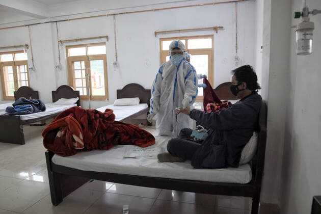 May 8, 2021: A Health worker examins a Covid-19 patient at a temporary Covid-19 hospital in Srinagar, Indian Administered Kashmir on 08 May 2021. A Local NGO Athrout has converted Hajj house into a 100-bedded Covid centre as the space in hospitals is filling up fast - ZUMAd99_ 20210508_zap_d99_063 Copyright: xMuzamilxMattoox