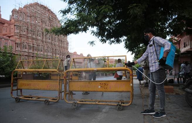 JAIPUR, INDIA - MAY 10: A volunteer sanitises police barricades opposite Hawa Mahal during a Covid-19 induced lockdown on May 10, 2021 in Jaipur, India. (Photo by Himanshu Vyas Hindustan Times) Lockdown In Jaipur To Curb Covid Pandemic