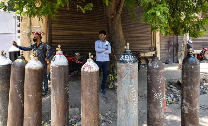 NEW DELHI, INDIA - MAY 11: People waiting to refill oxygen into empty cylinders at a centre at Mayapuri Industrial Area on May 11, 2021 in New Delhi, India. Oxygen has become a crucial medical resource because significantly more patients are suffering from breathlessness in this wave of infections. However with increasing supply of oxygen and decreasing active cases the rush at oxygen refilling center has decreased. (Photo by Amal KS Hindustan Times) Oxygen Supply For Covid Patients