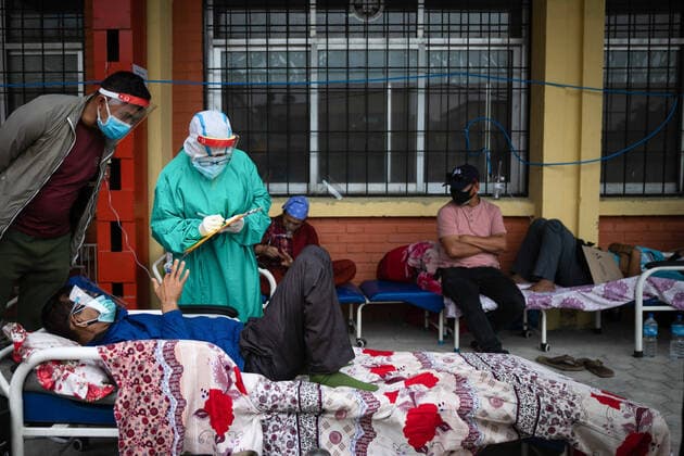 May 19, 2021, Kathmandu, Nepal: Nepalese health worker attends to a COVID-19 patient outside the hospital passage due the limited beds inside the Hospital..Nepal s Covid-19 death toll crossed the 4000-mark as staggering 225 deaths were reported on Tuesday. The total nationwide infection count has hit 413,111 with the addition of 9,317 fresh cases. Kathmandu Nepal - ZUMAs197 20210519_zaa_s197_002 Copyright: xPrabinxRanabhatx
