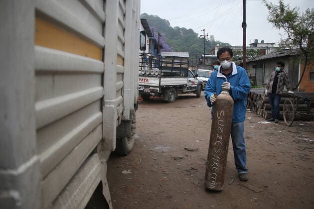 May 12, 2021, Kathmandu, NE, Nepal: Relative of a COVID-19 infected patient rush towards a Oxygen Plant in Kathmandu on 12th May, 2021 to get it refilled. Nepal is facing crunch of oxygen shortage with rise in Corona virus cases. Kathmandu Nepal - ZUMAd164 20210512_zip_d164_005 Copyright: xAryanxDhimalx