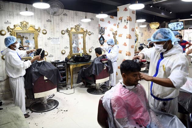 May 12, 2021, Dhaka, Bangladesh: Barbers wearing personal protective equipment (PPE) as a preventive measure against the spread of COVID19 attend to their salon clients in Dhaka. Dhaka Bangladesh - ZUMAs197 20210512_zaa_s197_063 Copyright: xPiyasxBiswasx