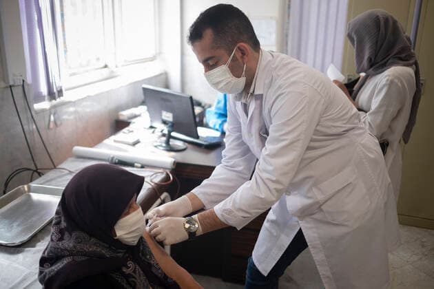 Vaccination Of People Over 80 Years By The AstraZeneca And Sinopharm COVID-19 Vaccines In Tehran An Iranian elderly woman wearing a protective face mask receives a dose of the South Korea AstraZeneca new coronavirus disease (COVID-19) vaccine, at the west Tehran health center on May 11, 2021. Tehran Tehran Iran nikoubazl-vaccinat210511_np64E  Copyright: xMortezaxNikoubazlx