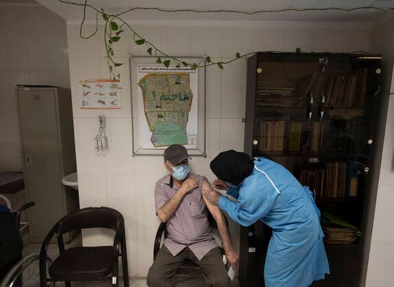 Vaccination Of People Over 80 Years By The AstraZeneca And Sinopharm COVID-19 Vaccines In Tehran An Iranian elderly man wearing a protective face mask receives a dose of the China s Sinopharm new coronavirus disease (COVID-19) vaccine, at the west Tehran health center on May 11, 2021. Tehran Tehran Iran nikoubazl-vaccinat210511_npg3i  Copyright: xMortezaxNikoubazlx