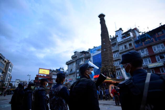 Longest Festival Rato Machindranath Begins During Prohibitory Lockdown In Kathmandu Valley Nepalese Police guard around the chariot during procession of Rato Machindranath towards the chariot on the first day of the longest chariot festival of Nepal during prohibitory lockdown of covid pandemic in Lalitpur, Nepal on Wednesday, May 12, 2021. Rato Machindranath is also said as the God of Rain and both Hindus and Buddhists worship the Machindranath in hope of good rain to prevent drought during the rice plantation season. Lalitpur NP Nepal maharjan-longestf210512_npuOK  Copyright: xNarayanxMaharjanx
