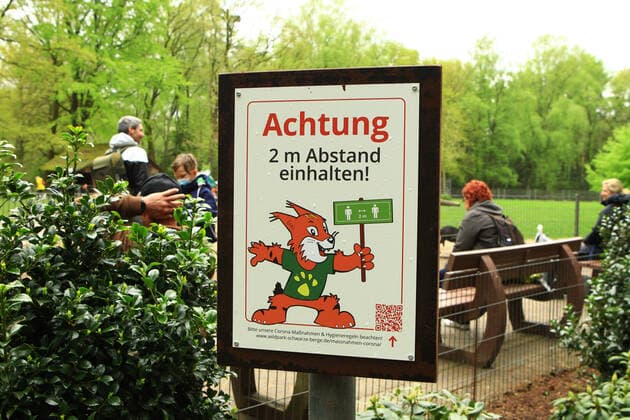 A sign in the Schwarze Berge Game Park in Rosengarten, Lower Saxony, informs visitors that the minimum distance of two metres must be observed in this area of the park south of Hamburg Rosengarten Lower Saxony