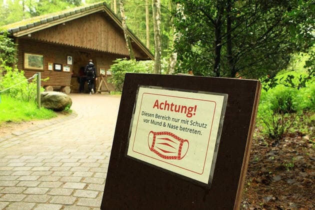 In the Schwarze Berge wildlife park in Rosengarten, Lower Saxony, a sign informs visitors that masks are compulsory in this area of the park Rosengarten Lower Saxony