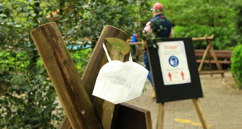 A mouth-nose mask hangs from a pole in the Schwarze Berge wildlife park in Rosengarten, Lower Saxony In the park south of Hamburg, masks are compulsory in certain areas Rosengarten Lower Saxony